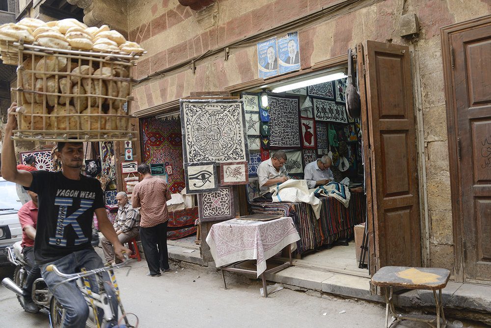 The Kheyameya artists in Egypt stitching wall hangings designed by Anthony Burrill